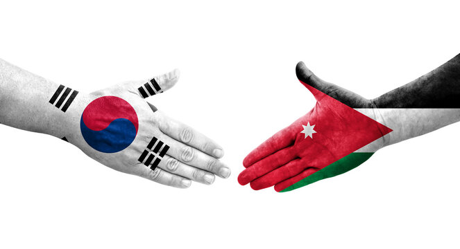 Handshake between South Korea and Jordan flags painted on hands, isolated transparent image.