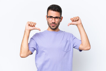 Fototapeta premium Young caucasian man isolated on white background proud and self-satisfied