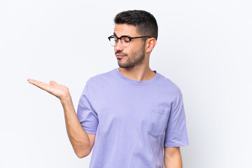 Fototapeta premium Young caucasian man isolated on white background holding copyspace with doubts