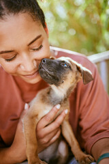 Love, care and pet dog with black woman in garden for bond, affection and happiness together. Wellness, calm and healthy adoption puppy bonding embrace with happy girl owner in backyard.
