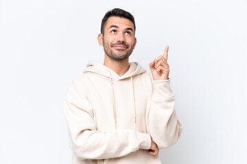 Fototapeta premium Young caucasian man isolated on white background pointing up a great idea