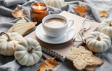 White pumpkins, coffee and autumn leaves