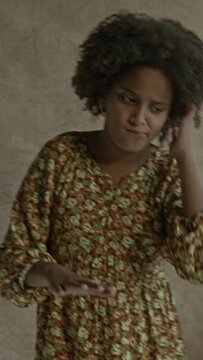 young black girl, afro hair, pretending to DJ,play instrument, laughing