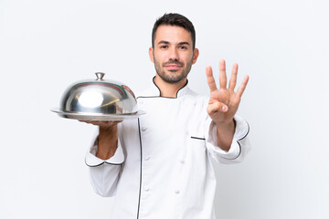 Young chef with tray isolated on white background happy and counting four with fingers