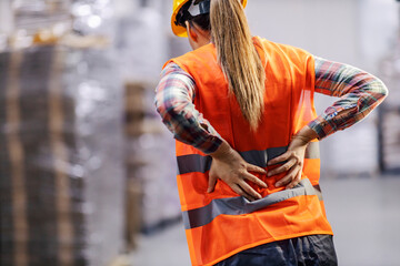 A storage worker having back pain and holding spine. - obrazy, fototapety, plakaty