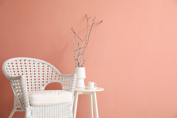 Interior of stylish living room with white armchair and table