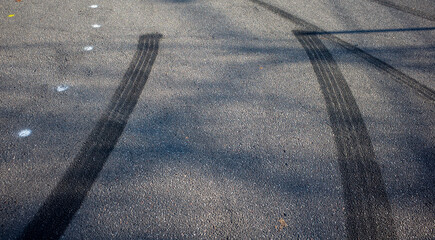skid marks on a road surface. acceleration or braking marks left by street race drivers 