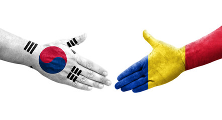 Handshake between South Korea and Romania flags painted on hands, isolated transparent image.
