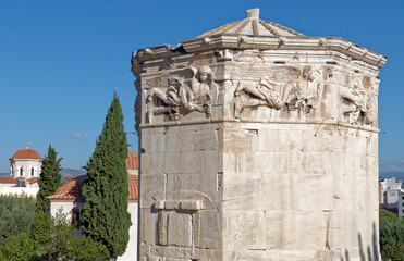 Fototapeta na wymiar The Wind's Tower in the roman forum under a pristine blue sky. Travel in Athens, Greece.