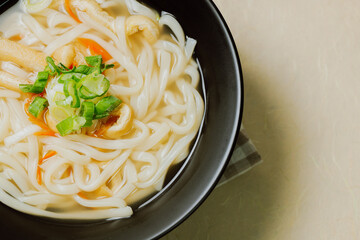 Kalguksu, Korean style noodle soup :Fresh knife-cut noodles, made by rolling flour dough and slicing into thin noodles, cooked in anchovy sauce. Zucchini, potatoes, and seafood may beadded.