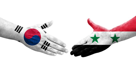 Fototapeta premium Handshake between South Korea and Syria flags painted on hands, isolated transparent image.