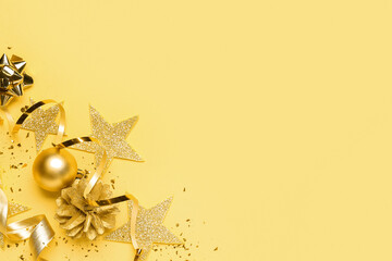 Composition with beautiful Christmas decorations, serpentine and confetti on yellow background