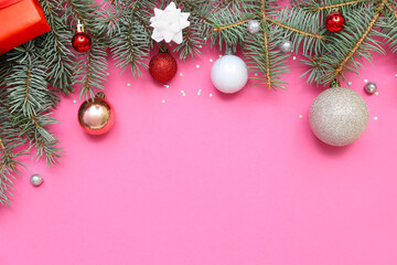 Composition with fir branches and beautiful Christmas balls on pink background