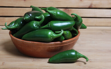 Bowl of Fresh Green Jalapeno Peppers in Rustic Kitchen