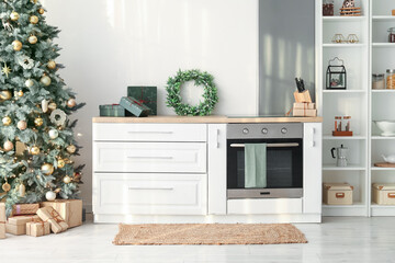 Interior of kitchen with Christmas tree, mistletoe wreath and counter