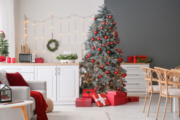 Interior of kitchen with Christmas tree and white counters