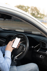 Driver showing a smartphone with a white screen