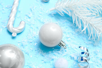 Composition with Christmas decorations and snow on color background, closeup