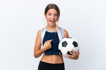 Little caucasian girl playing football isolated on white background with surprise facial expression