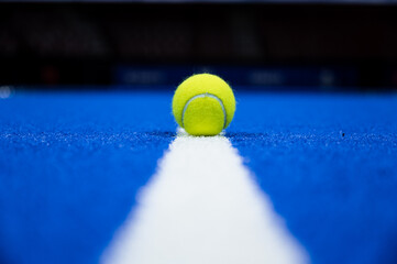 Padel ball on the line of the court