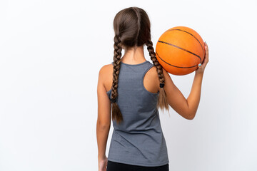 Little caucasian girl isolated on white background playing basketball in back position
