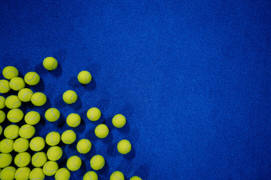 Combination of padel balls on the court in the left corner