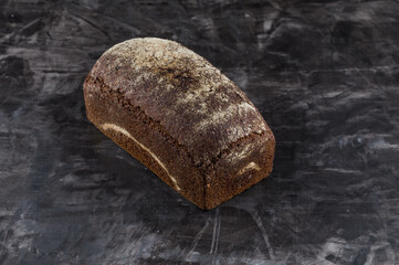 Rye bread on dark board background