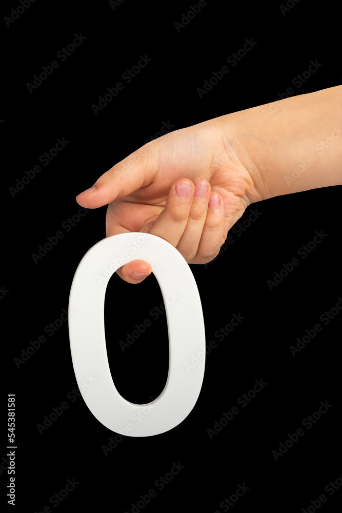 Aufkleber zero in hand. the number zero is clasped in a hand isolated on a black background. number zero white