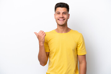 Young caucasian man isolated on white background pointing to the side to present a product