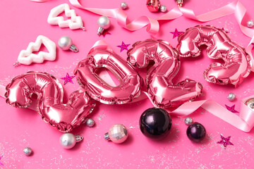 Figure 2023 made of balloons, Christmas decorations and ribbon on pink background, closeup