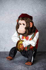 Retro toy monkey jolly chimp with cymbals on gray surface 