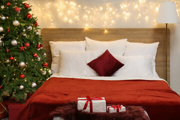 Interior of bedroom with glowing lights and Christmas tree