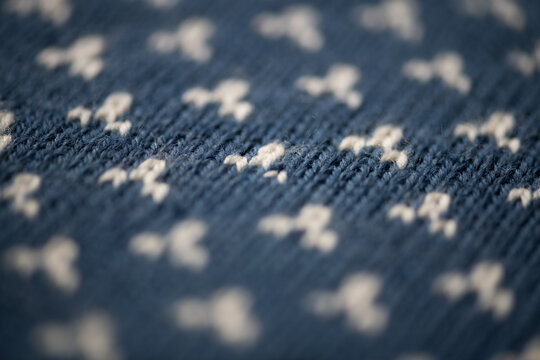 closeup macro of woolen knitted blue sweater texture in winter pattern 