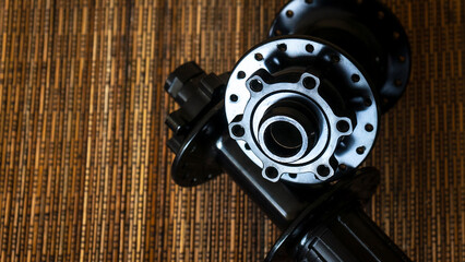 Close up of mountain bike hub on wooden background. Bicycle components. Cycling equipment.