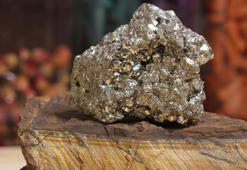 Pyrite Specimen on Raw Tigers Eye Rock With Dried Herbs in Background