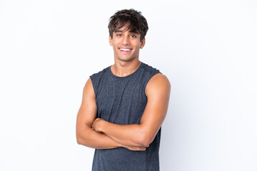 Young sport caucasian man isolated on white background with arms crossed and looking forward