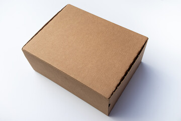 Cardboard mail box for sending. Courier delivery of cargo.A clean craft box on a white background. A box with a hinged lid and a clean place for the inscription.