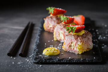 Delicious sweet sushi sprinkled with coconut shavings.