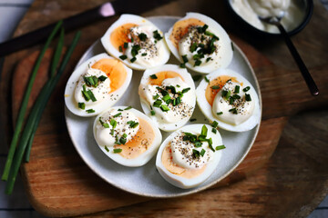 Boiled egg halves with mayonnaise and green onions.