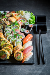 Aromatic na fresh sushi set made of avocado and salmon. © shaiith