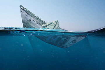 Concept paper dollar boat sinking in the sea with a view underwater. Finance and crisis, a creative idea. Falling exchange rates. Insurance - obrazy, fototapety, plakaty
