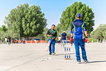 local people playing cricket sport