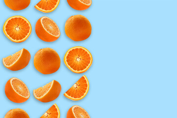 Orange whole and cut on a blue background in three rows with space for text.