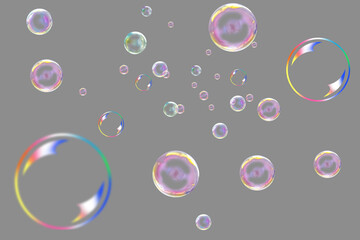Many multi-colored soap bubbles on a gray background.