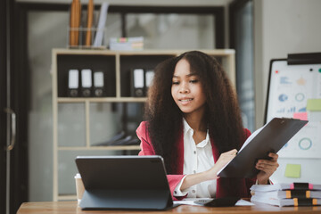 American woman sits in the office of a startup company, she is a company employee, young generation operations run the company with the concept of the new generation. Company management concept