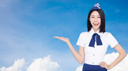 Happy Beautiful stewardess showing something on cloud background
