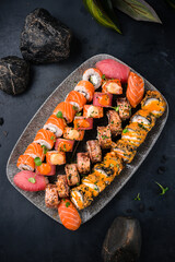 Varied sushi roll set with salmon, tuna, shrimp, eel, avocado, cream cheese, cucumber.