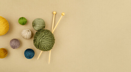 Row of various size and color woollen balls of yarn as a left border frame. Craft, knitting or hand made concept. Winter creative hobby background. Top view, flat lay, copy space.