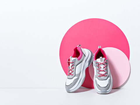 Reducing weight, getting fit and healthy life concept. Bright scene with chunky sneakers. Colorful casual wear or sport shoes. Minimal fashion fitness creative concept. Sport and fitness themed frame.