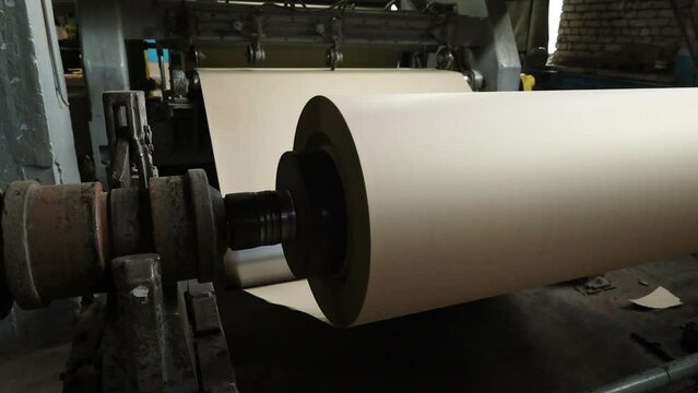 the paper-making machine produces technical cardboard at an old boomkombinat